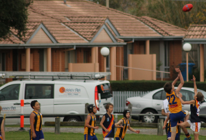 Young boys of St Bedes Mentone Junior Footy Club wearing surrey air jumpers