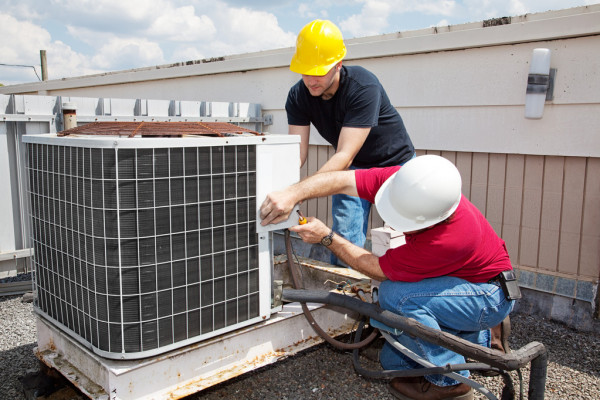 two men doing commercial air conditioning service