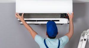 man checking air conditioner for efficient electricity bill