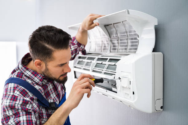 man doing air conditioning maintenance happily