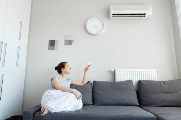 Young woman chilling in her lounge after split system repair
