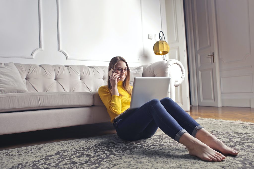 woman chilling in her living room working on her laptop