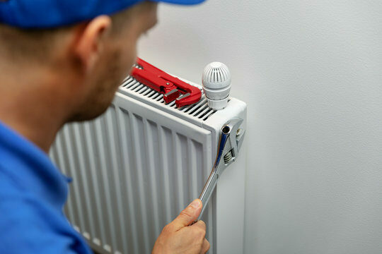 Technician doing Heating installation in Hampton