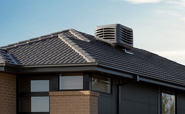 Evaporative air conditioner system mounted on a rooftop of a home in Melbourne