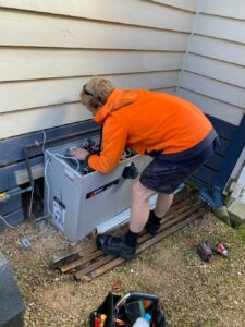 Surrey air technician doing heating system servicing in Melbourne