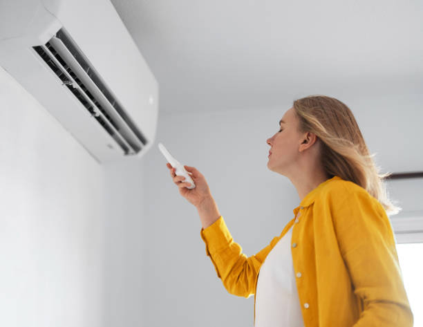woman using air conditioner in summers