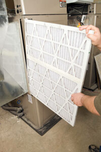 Surrey air technician changing HVAC filter