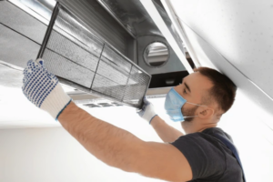 Surrey air technician doing air conditioning duct cleaning