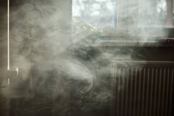 A scenic view of a kitchen with full of dense vape smoke that is being backlit by the sunlight.