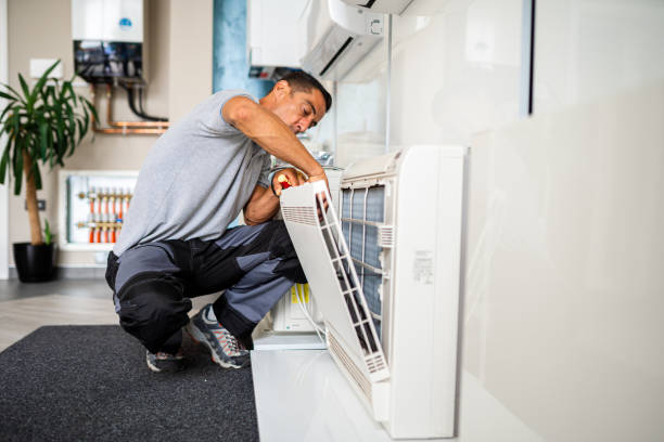 Surrey air technician cleaning hvac duct for efficient working