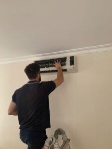 Surrey air technician installing a split system in Melbourne