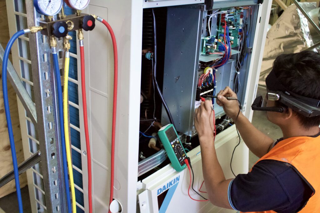 Surrey Air technician providing air conditioner repair