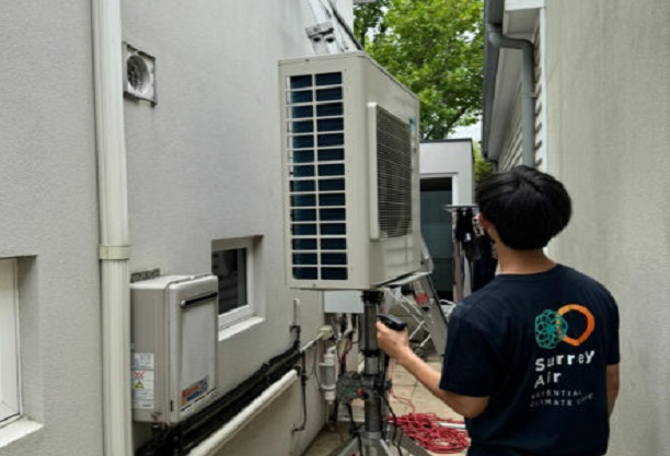 Surrey air technician doing air conditioning repair