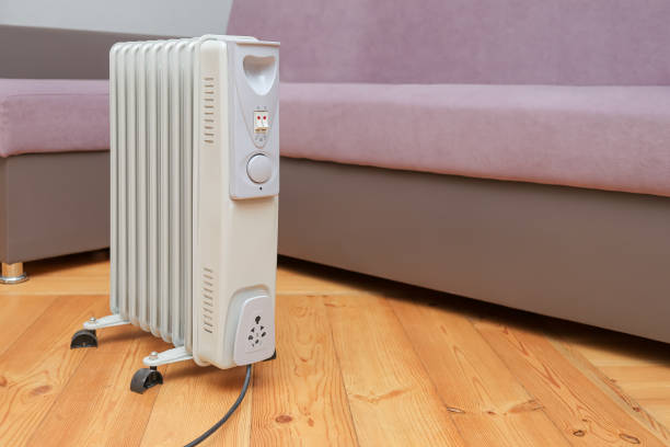 oil heater stands on the floor near the sofa.