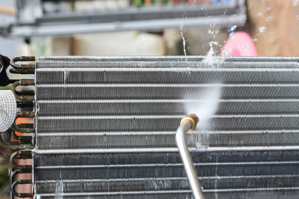 air conditioner condensor coil getting cleaned