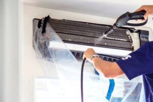 surrey air technician doing air conditioner cleaning