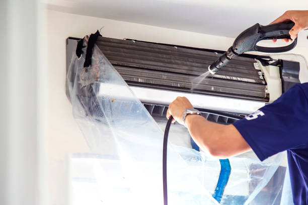 surrey air technician doing air conditioner cleaning